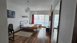 a bedroom with a bed and a room with a window at Luca Apartament in Bucharest