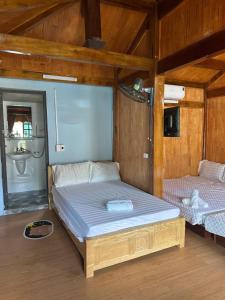 a bedroom with a bed and a sink at Nhà trên đồi - Windy Hill in Mù Cang Chải