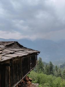an old wooden building sitting on top of a hill at Roohi in Nagar