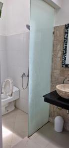 a bathroom with a toilet and a sink at Cozy 1Bedroom House with Kitchen Work Space in Nusa Dua