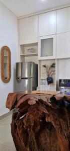 a kitchen with a large wooden log on the counter at Cozy 1Bedroom House with Kitchen Work Space in Nusa Dua +8 photos