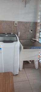 a white toilet sitting in a room next to a table at Espaço da paz in Joinville +2 photos