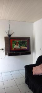 a flat screen tv on a wall in a living room at Espaço da paz in Joinville