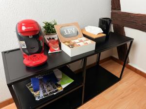 a table with a hello kitty hair dryer and a box at Le Cocon Alsacien au cœur de Rouffach in Rouffach
