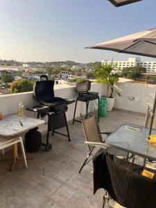 a patio with chairs and tables on a roof at Hostel HA LUXURY in Cartagena de Indias