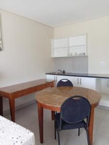 a kitchen with a wooden table and two chairs at Hlalanathi Lodge - 9 Shepstone Road, Harding in Harding