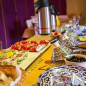 a table with plates of food on it at hagra luxury camp Merzouga in Merzouga