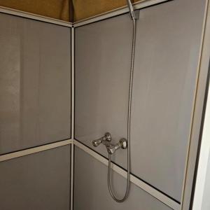 a shower in a bathroom with a hose at hagra luxury camp Merzouga in Merzouga