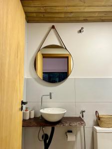 a bathroom with a sink and a mirror on the wall at Suíte em Trindade, Praia Brava, na Mata in Paraty