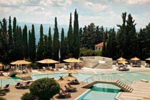 a view of a pool with umbrellas and chairs at Zeus Eretria Resort in Eretria