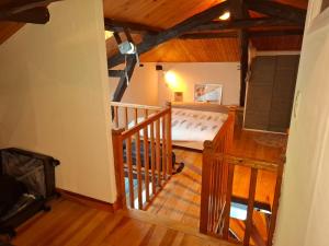 an attic room with a bed and a staircase at Les Mas d Olema in Puy-lʼÉvêque