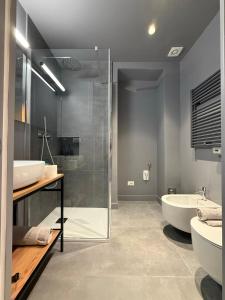 a bathroom with two sinks and a glass shower at THE DESIGNER HIDE OUT - Casa Vacanze in Turin