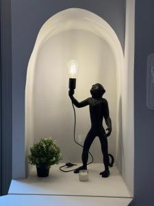 a statue of a person holding a light bulb at THE DESIGNER HIDE OUT - Casa Vacanze in Turin