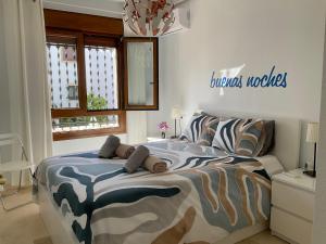 a bedroom with a bed with a comforter on it at Gound Floor Bungalow Jumilla III Playa Flamenca in Orihuela Costa