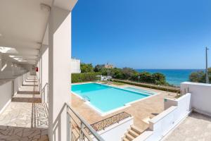 a view of the swimming pool from the balcony of a house at Residence Solaris in San Foca
