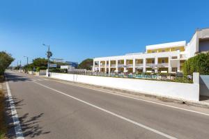 an empty street in front of a building at Residence Solaris in San Foca