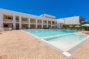 a large swimming pool in front of a building at Residence Solaris in San Foca +8 photos