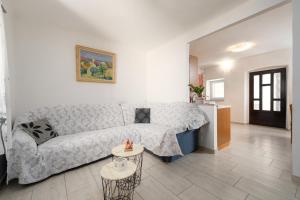 a living room with a couch and a table at Casa Nadia by Briskva in Mošćenička Draga