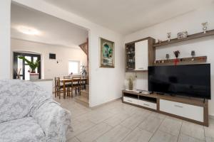 a living room with a large flat screen tv at Casa Nadia by Briskva in Mošćenička Draga