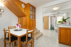 a kitchen and dining room with a table and chairs at Casa Nadia by Briskva in Mošćenička Draga +21 photos