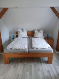 two beds with white pillows on them in a room at Haus Carl-Hubert -Schwerin Görries - in Klein Rogahn