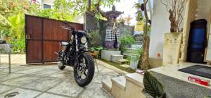 a motorcycle parked in front of a garage at Cozy 1Bedroom House with Kitchen Work Space in Nusa Dua