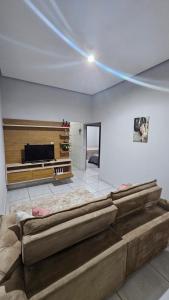a bedroom with a large bed in the middle of a room at Casa próxima à Praia do Cerrado e centro in Goianésia