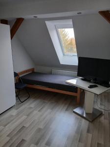 a room with a bed and a desk and a window at Haus Carl-Hubert -Schwerin Görries - in Klein Rogahn +4 photos