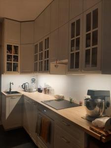 a kitchen with white cabinets and a mixer on a counter at L'Ultra Pause au cœur du Viroin in Olloy-sur-Viroin