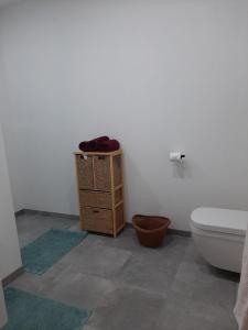 a bathroom with a toilet and a wooden cabinet at L'Ultra Pause au cœur du Viroin in Olloy-sur-Viroin +22 photos