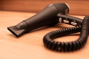 a black corded telephone sitting on top of a table at BDB-Kulturhotel in Staufen im Breisgau