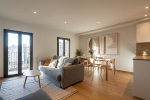 a living room with a couch and a table at Modern apartments in one building, in the heart of Girona in Girona