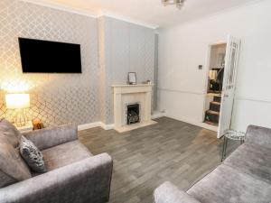 a living room with a couch and a fireplace at Chestnut Lodge in Bradford