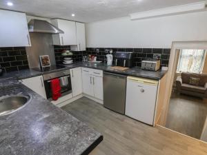 a kitchen with a sink and a counter top at Chestnut Lodge in Bradford