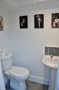 a bathroom with a white toilet and a sink at Ash Cottage - Caerleon in Newport +19 photos