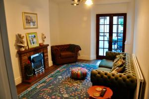 a living room with a couch and a fireplace at Ash Cottage - Caerleon in Newport