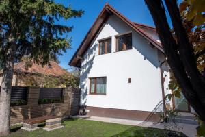 a white house with a red roof at DIM Studio in Braşov