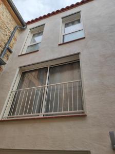 a building with a window with blinds on it at La chambre des tentations , love room avec jacuzzi in Bages