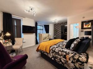 a bedroom with a bed and a living room at The Arthington in Blackpool