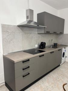 a kitchen with a sink and a stove at Il vicoletto in Sulmona