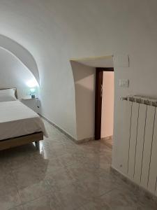 a bedroom with a bed and a room with a hallway at Il vicoletto in Sulmona