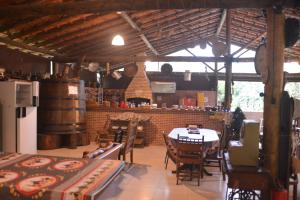 a kitchen and dining room with a table and chairs at Rancho Potala in Bairro Pedra Branca