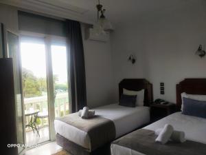 a hotel room with two beds and a balcony at Royal Hotel Rabat in Rabat +38 photos
