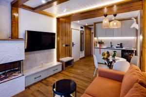a living room with a couch and a dining room at Celeste Luxury Apartments in Ranca