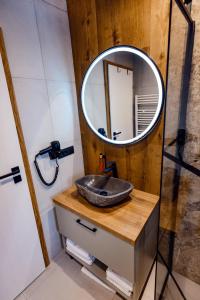 a bathroom with a sink and a mirror at Celeste Luxury Apartments in Ranca +40 photos