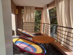 a balcony with a table and two chairs at La Perle Ourika Valley Guest House in Ourika