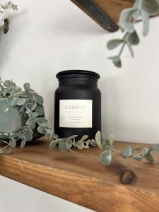 a candle sitting on a shelf with a plant at LODGE Nuthatch in Droitwich