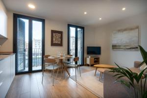 a kitchen and dining room with a table and chairs at Modern apartments in one building, in the heart of Girona in Girona
