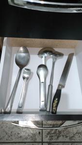 a group of silver utensils in a drawer at Sobrado há 7 quadras da praia in Matinhos