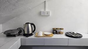 a kitchen counter with a coffee maker and utensils at Home Stay by 98 in Dambulla